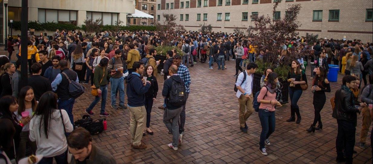 A wideshot of Ancel Plaza filled with around 500 students talking to each other during FestiFall 2015